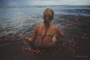 A girl in flowers in the sea in India