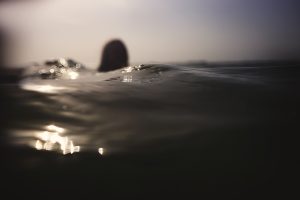 A an out of focus girl floating in the dark sea